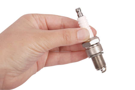 New sparking plug in a hand on a isolated white background. Photo with clipping pathの写真素材