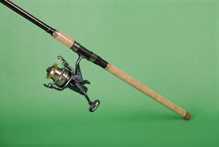 Fishing rod on green background with soft shadow