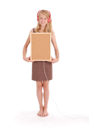 Teenage girl in headphones, holding cork board. Isolated on white backgroundの写真素材
