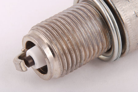 One new spark plug on a gray background