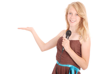 Beautiful teenage girl with microphone isolated on white backgroundの写真素材