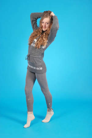 Cheerful young girl are standing against the blue backgroundの写真素材