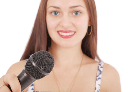 Happy young beautiful girl singing with microphone isolated on white backgroundの写真素材