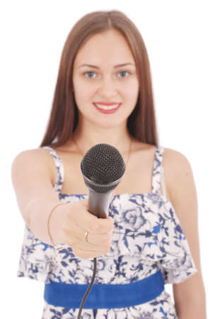Happy young beautiful girl singing with microphone isolated on white backgroundの写真素材
