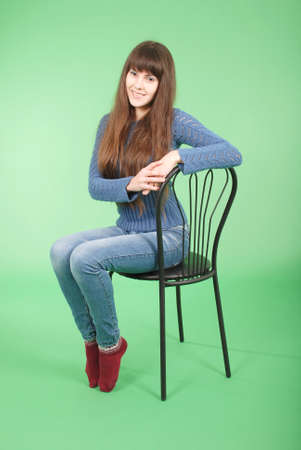 Cheerful young girl are standing against the green backgroundの写真素材