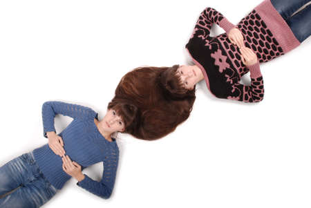 Portrait of two twins sisters with long hair, top view on white backgroundの写真素材