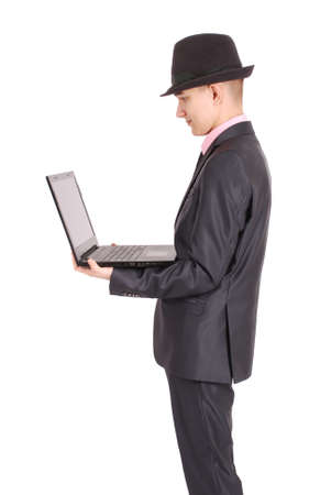 Full length portrait of confident mature businessman with a laptop in formals standing isolated over white backgroundの写真素材