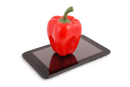 Red pepper on a tablet PC. Photo with clipping pathの写真素材