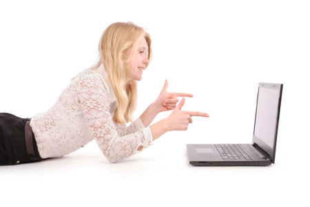 Pretty young teenage girls with laptop lying on the floor. isolated on whiteの写真素材