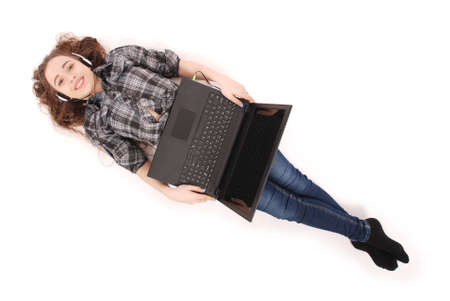 Young girl lying and using a laptop, isolated on whiteの写真素材