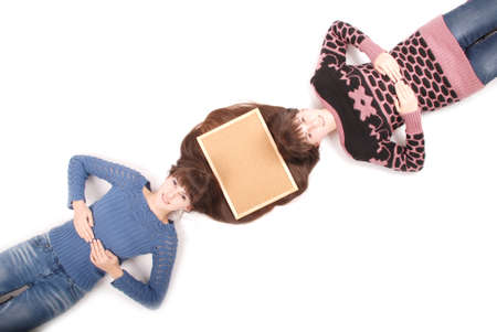 Portrait of two twins sisters with long hair and cork board on the hair, top view on white backgroundの写真素材