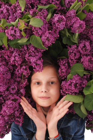 Beautiful young girl with Blooming flowers on her head. Isolated on white background.の写真素材