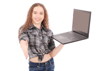 Young girl standing and using a laptop, isolated on white
