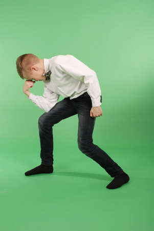 Happy young boy isolated on green backgroundの写真素材