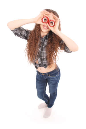Portrait of a funny young girl looking at camera through insulating tape isolated on a white backgroundの写真素材