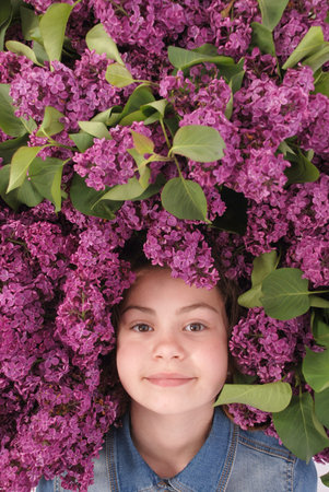 Beautiful young girl with Blooming flowers on her head. Isolated on white background.の写真素材
