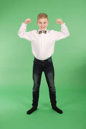 Happy young boy isolated on greenの写真素材