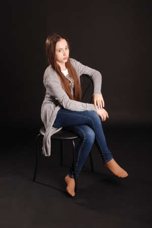 Portrait of gorgeous young girl over black backgroundの写真素材