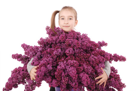 Attractive girl standing by the lilac. Isolated on a white background