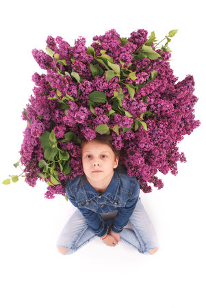 Beautiful young girl with Blooming flowers on her head. Isolated on white background.の写真素材