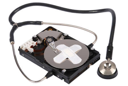 Destroying data from hard disk - conceptual photo. Hard drives and Stethoscope. On white backgroundの写真素材