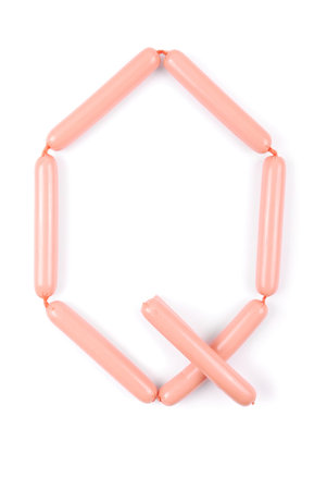 Alphabet letter Q arranged from sausage isolated on the whiteの写真素材