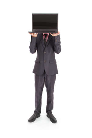 Full length portrait of confident young businessman which face that keeps laptop in formals sitting isolated over white backgroundの写真素材