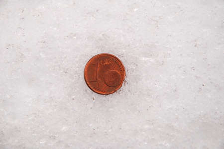 The lost coins on a snow. Euro coinの写真素材