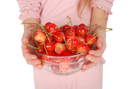 Crockery with cherries in woman hands. Isolated on a white background.の写真素材
