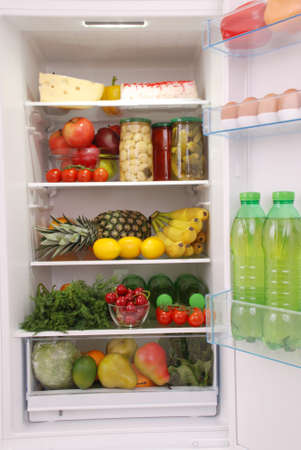 Open refrigerator full with some kinds of food and drinksの写真素材