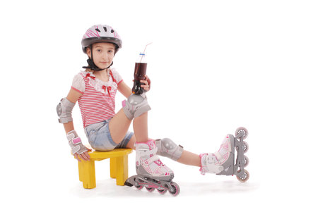 Charming broun-haired girl of school age in short jeans shorts and a pink t-shirt sitting on the...