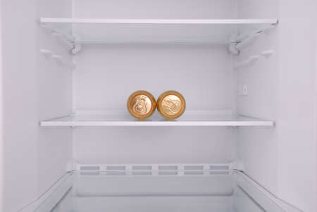 Two metal beer cans inside in empty clean refrigerator with opened doorの写真素材