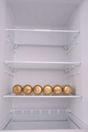 Six metal beer cans inside in empty clean refrigerator with opened doorの写真素材