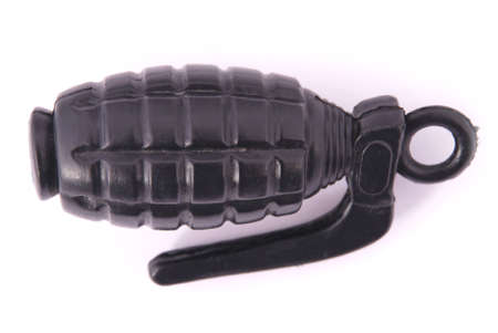 Black plastic toy grenade on a white backgroundの写真素材