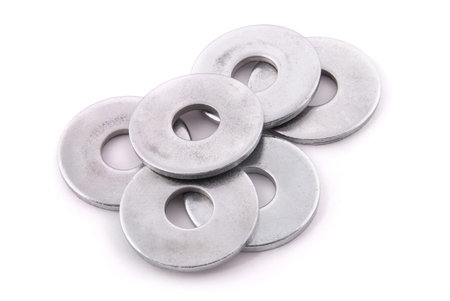 Flat metal washers and nut isolated on a white background