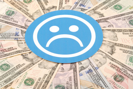 Blue sad smile faces on mandala kaleidoscope from money. Abstract money background raster pattern...