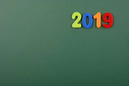 2019 year written in bright plastic magnetic letters stuck on a magnetic board