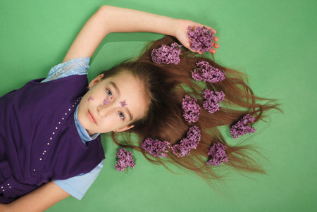 Girl with a lilac hairstyle on green background
