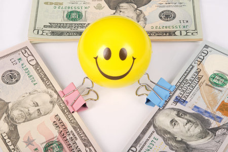 Yellow smile faces on money. Abstract money background isolated on whiteの写真素材
