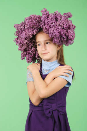 Girl with a lilac hairstyle on green backgroundの写真素材