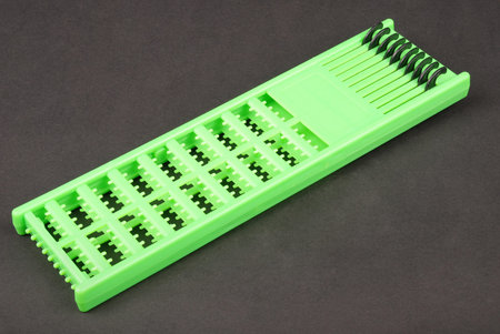One green hair extender stops isolated on black background
