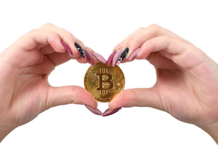Hands holds and shows the heart new golden cryptocurrency bitcoin in hands on white backgroundの写真素材