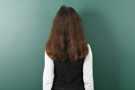 Smiling little schoolgirl on green school boardの写真素材