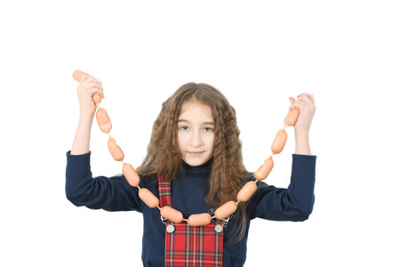 Young girl holds sausages isolated on white. High resolution photo.