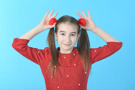 Full length studio photo girl wearing red dress standing on blue background.の写真素材