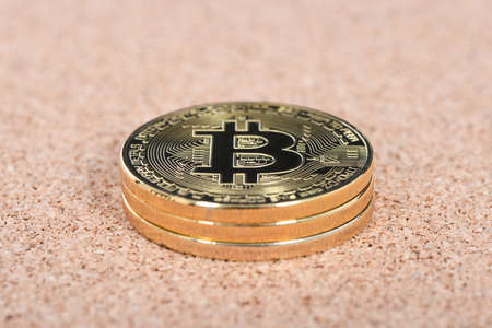 Golden bitcoin on brown textured cork. High resolution photo. Full depth of field.の写真素材