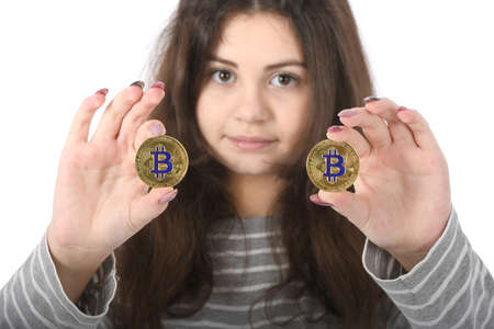 Pretty Girl holding new golden cryptocurrency bitcoin in hands on white backgroundの写真素材