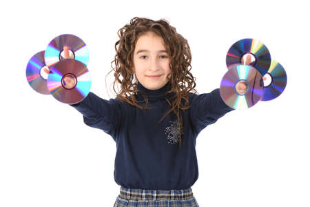 A young schoolgirl with curl hair holding cd or dvd. All isolated on white backgroundの写真素材