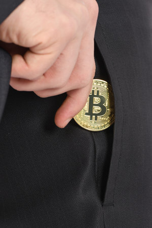 Man holding golden Bitcoin isolated on white background. High resolution photo. Full depth of field.の写真素材