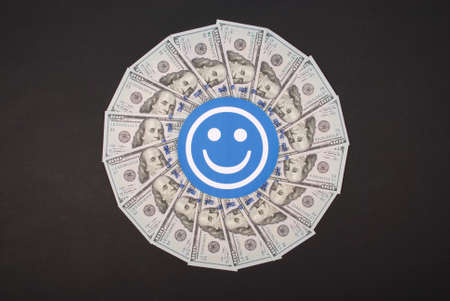 Smile faces on mandala kaleidoscope from money. Abstract money background raster pattern repeat mandala circle.の写真素材